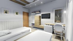 a bedroom with a bed and a desk and a tv at Kuća za odmor Vila in Vrsar