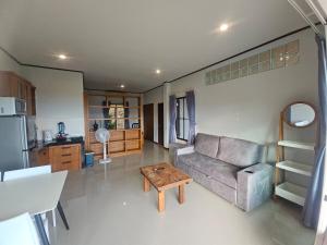 a living room with a couch and a table at Seaview Studio Jungle in Lamai