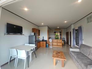 a living room with a couch and a table at Seaview Studio Jungle in Lamai