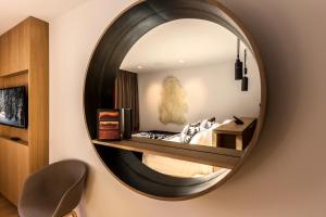 a mirror on a wall in a room at Le Yule Hotel & Spa in Val-d'Isère