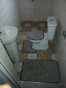 a bathroom with a toilet and a sink at Guest Apartments in New Weija