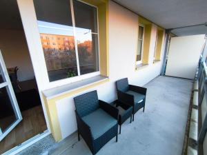 an empty room with two chairs and two windows at Business Apartment Chemnitz in Chemnitz