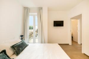 Postel nebo postele na pokoji v ubytování Palazzo Terra Madre Luxury Accomodations