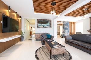 a living room with two couches and a tv at INFINITY PREMIUM Villas in Kos Town