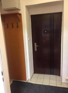 a black door in a room with a kitchen at Apartment UNA - self check in in Graz