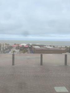 a view of a beach with umbrellas and the ocean at Blankenberge seawall in Blankenberge