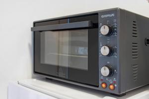 a microwave oven sitting on top of a shelf at Platinum - Il Centro Luxury Suites in Bari