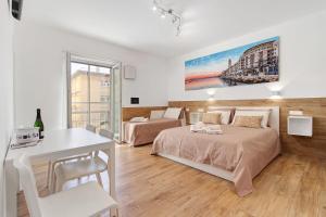 a bedroom with two beds and a table and a desk at Platinum - Il Centro Luxury Suites in Bari