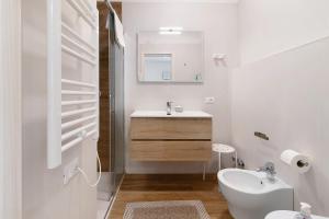 a white bathroom with a sink and a toilet at Platinum - Il Centro Luxury Suites in Bari +18 photos