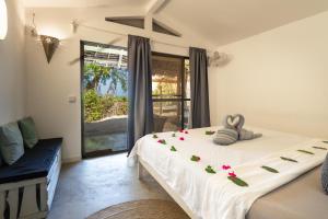 a bedroom with a bed with flowers on it at B4 Beach Club in Paje +131 photos