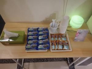 a table topped with lots of different types of snacks at Vitro Hotel in Johor Bahru