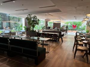 a restaurant with tables and chairs and a bar at Vissai Saigon Hotel in Ho Chi Minh City