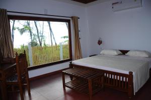 Alleppey Beach Garden客房内的一张或多张床位
