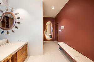 a bathroom with a sink and a mirror on the wall at Gate 11 Spacious Apartment 1 Stylish 3rd Floor in Seminyak