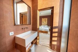 a bathroom with a sink and a mirror at Gate 11 Spacious Apartment 1 Stylish 3rd Floor in Seminyak