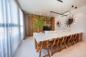 a dining room with a table and chairs at Gate 11 Spacious Apartment 1 Stylish 3rd Floor in Seminyak