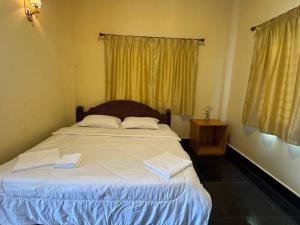 Ένα ή περισσότερα κρεβάτια σε δωμάτιο στο Kim Hong Guesthouse +1 φωτογραφίες