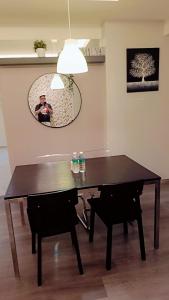 a dining room table with two bottles of water on it at Lumut Valley in Lumut