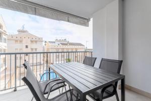 a dining table and chairs on a balcony with a view at Mar 4 en Santa Pola in Santa Pola