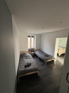 a room with two beds and a window at A l'ancienne boulangerie, proche de Colmar et des plus beaux villages en Alsace in Meyenheim +40 photos