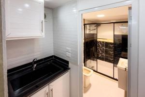 a small bathroom with a sink and a toilet at Rose In Apartment in Wadi Musa