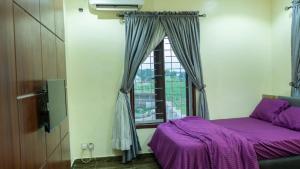 a bedroom with a purple bed and a window at Camp Ground 