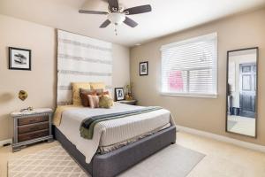 a bedroom with a bed and a ceiling fan at Ventura Blvd Guest House in Litton Industries Heliport