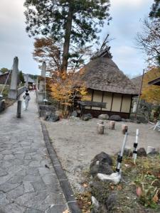a building with a stone walkway in front of a building at HAKUBA IKEDA LIFE KAN APARTMENTS in Hakuba +43 photos