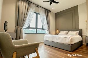 a bedroom with a bed and a chair and a window at Onsen Suite Theme Park View in Ipoh +35 photos