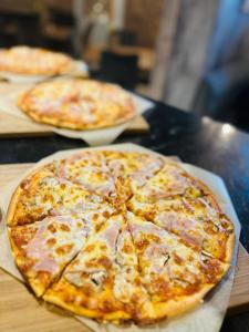 two pizzas sitting on top of a table at Hotel Dana in Bytów +33 photos
