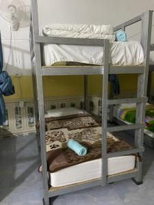 two bunk beds in a room with a bed at Mekong Backpackers 2 PB in Pakbeng +15 photos