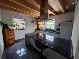 a kitchen with a black counter top in a room at Wellness-Villa-Eifel 3 Schlafzimmer in Mechernich