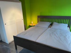 a bedroom with a bed with a green wall at Wellness-Villa-Eifel 3 Schlafzimmer in Mechernich +39 photos