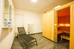 a room with a chair and a desk and a table at Ferienanlage La Gerbia in Cannobio