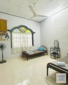 Postel nebo postele na pokoji v ubytování Homestay AZ Padang Serai