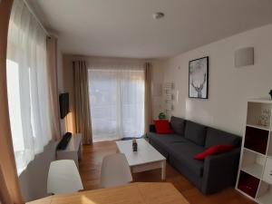 a living room with a couch and a table at Modernes Apartment - Nockberge in Ebene Reichenau