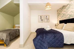 a bedroom with a large bed with a blue blanket at Relaxed, Spacious & Ideal for Small Families in Bournemouth