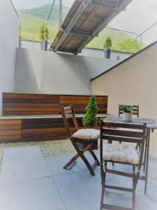 a patio with a table and chairs and a bench at Modernes Apartment - Nockberge in Ebene Reichenau
