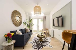 a living room with a couch and a tv at Relaxed, Spacious & Ideal for Small Families in Bournemouth