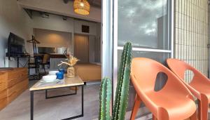 a living room with a cactus and a table and chairs at Prince Plage Okinawa 406 PP46 in Fuzuchi