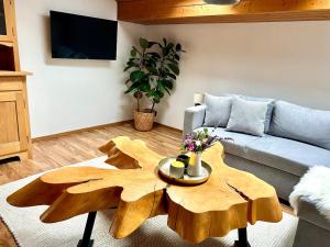 a living room with a couch and a wooden coffee table at Castle and Alps Appartement in Halblech