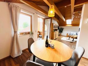 a dining room with a wooden table and chairs at Castle and Alps Appartement in Halblech