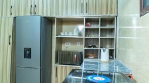a small kitchen with a counter and a refrigerator at Camp Ground  +9 photos