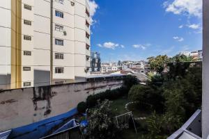a view of a tall building from a balcony at Studio Novo com ar ao lado da Igreja São Mateus in Juiz de Fora