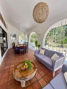 a living room with a couch and a table at Sandbox in Kilifi