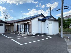 an empty parking lot in front of a building at EASE-Takasaki-Yawata in Takasaki