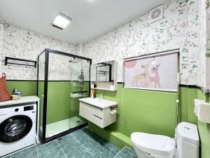 a bathroom with green walls and a washing machine at Shanghai Zighouse--The Bund Premium Apartment Suites in Shanghai