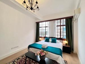 a bedroom with a large bed with blue pillows at Shanghai Zighouse--The Bund Premium Apartment Suites in Shanghai