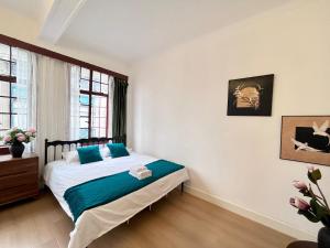 a bedroom with a bed with blue pillows at Shanghai Zighouse--The Bund Premium Apartment Suites in Shanghai +99 photos