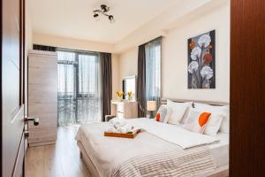 a bedroom with a large white bed and a window at Apart-hotel on Koghbatsi 16 in Yerevan